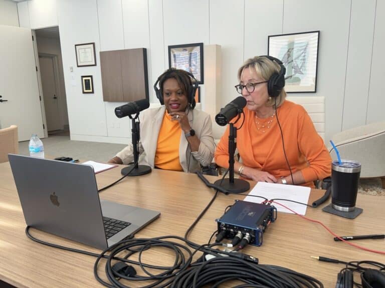 Vice Provost Amber Williams and Chancellor Donde Plowman in front of podcast microphones.