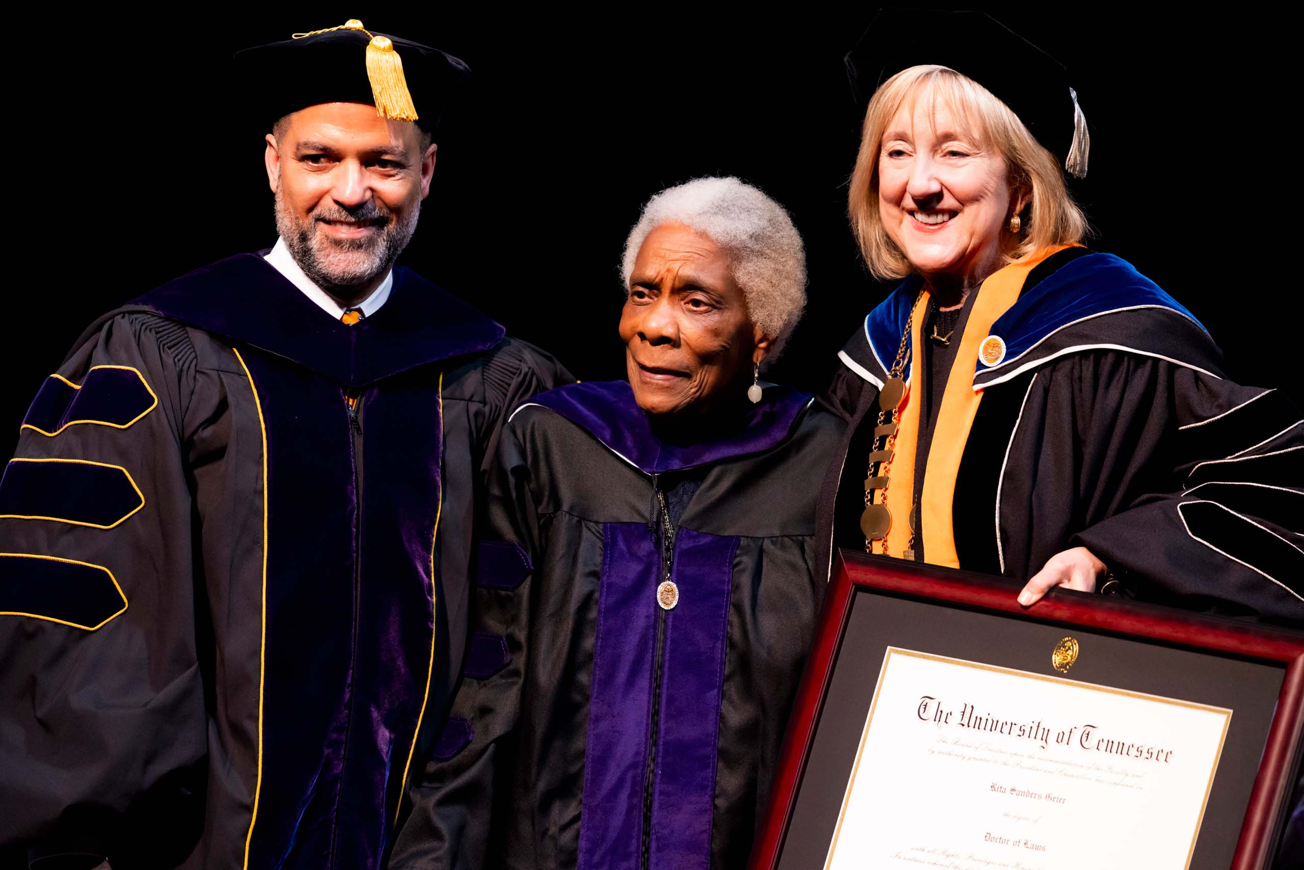 Chancellor Donde Plowman and College of Law Dean Lonnie T. Brown, Jr. pose with Rita Geier during commencement.